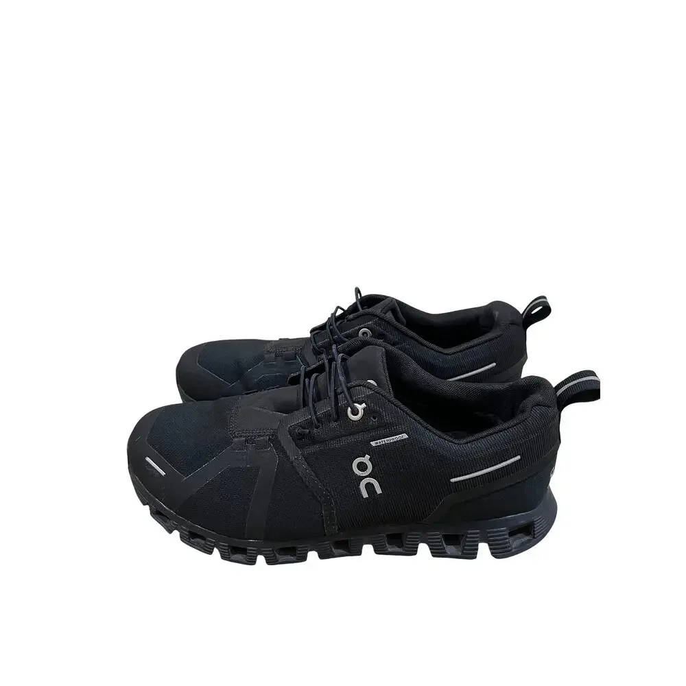 On Cloud waterproof running shoes for women in solid black.